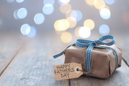 Fathers day gift with label on a wooden backgroundの写真素材