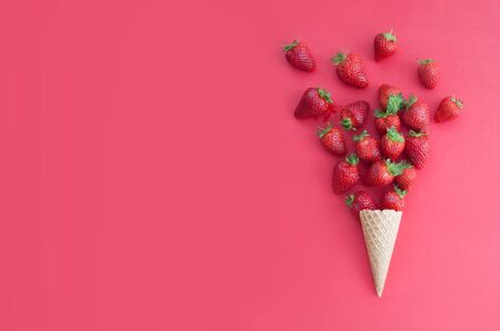 Strawberries falling out of an ice cream coneの写真素材
