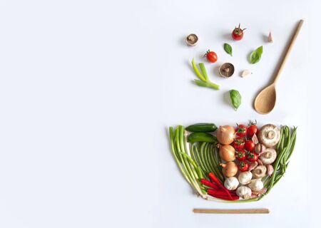 Vegetables in the shape of a soup bowl with wooden spoonの写真素材