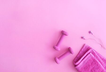 Excercise equipment including dumbbells towel and earbudsの写真素材