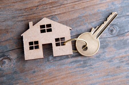 Key attached to a miniature wooden house の写真素材