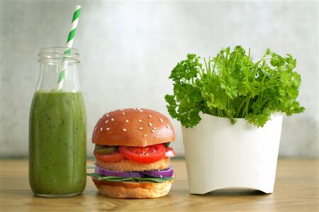 Healthy fast food, including burger, vegetable smoothie and salad in a french fries containerの写真素材