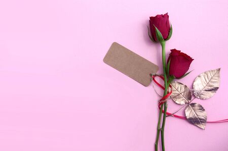 Red roses with gold leaves and blank greeting cardの写真素材