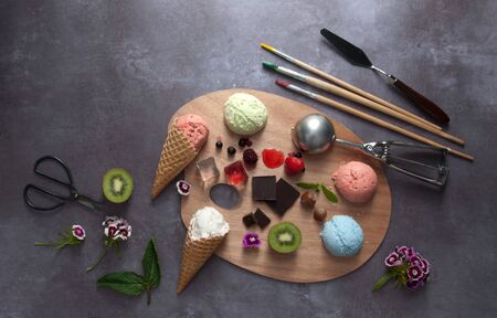 Assorted summer ice cream scoops on a painters palette with different flavours and ingredients
