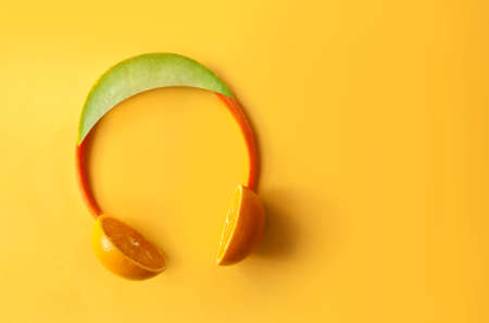Headphones made of fruits and vegetable including melon, carrots and orangesの写真素材