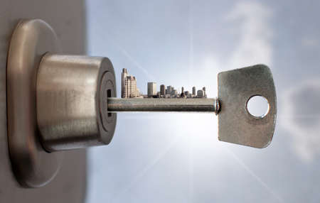 Key with city skyline inside a door lockの写真素材