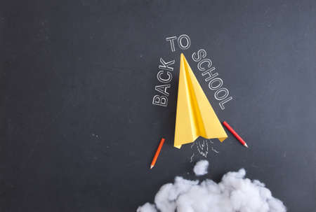 Paper plane on a blackboard with cotton wool smokeの写真素材