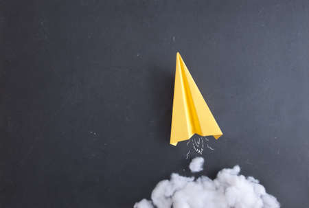 Paper plane on a blackboard with cotton wool smokeの写真素材