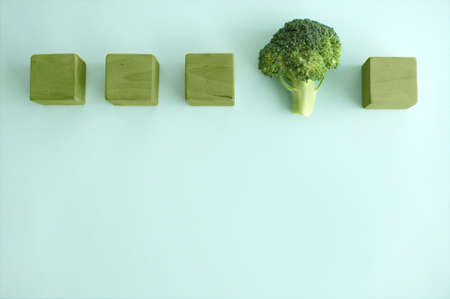 Broccoli floret standing out amongst green abstract cubes