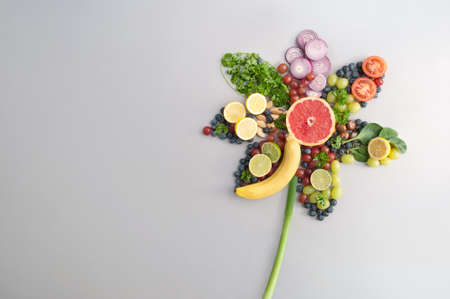 Summer salad ingredients, fruits and vegetables in the shape of a flowerの写真素材