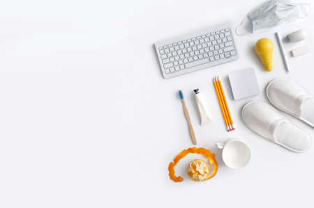 Work from home top view of workspace stationery with yellow light bulb in the centre, symbolising inspiration, motivation, ideasの写真素材