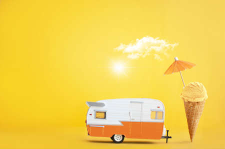 Toy camper van with ice cream cone and umbrellaの写真素材