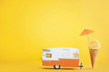 Toy camper van with ice cream cone and umbrellaの写真素材