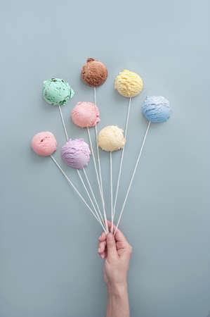 Hand holding ice cream cones like balloons, summer ice cream concept