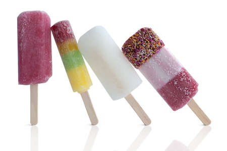 Four assorted ice lollies over a white backgroundの写真素材
