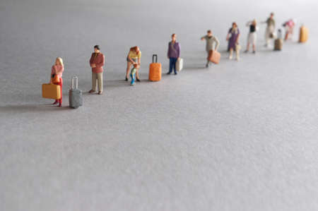 Miniature people, vacation travellers in queueの写真素材