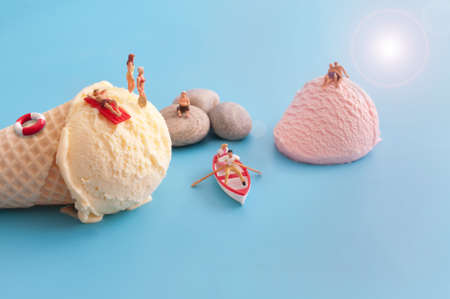 Miniature sunbathers on ice cream scoopsの写真素材