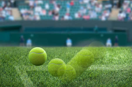 Closeup motion shot of wimbledon tennis ball bouncing on grass court surfaceの写真素材
