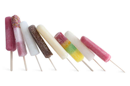Frozen assorted ice lollies on a white backgroundの写真素材