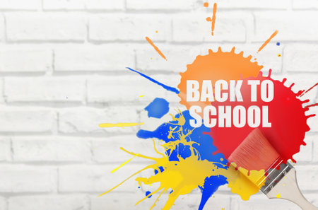 Back to school paint splash stencil with brush on brick wallの写真素材