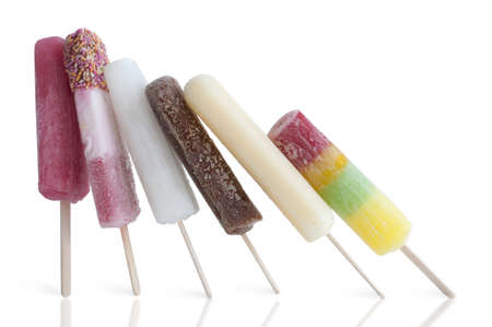 Frozen assorted ice lollies on a white backgroundの写真素材