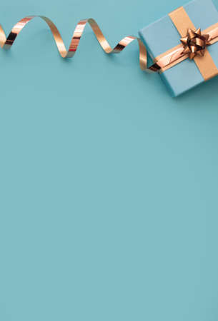 Seasonal gift box wrapped with with gold ribbon bowの写真素材
