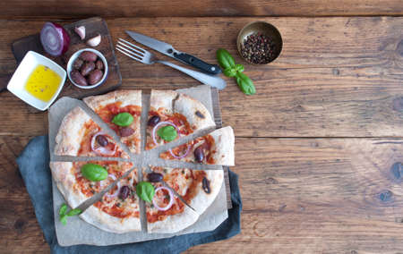 Sliced homemade stone baked italian pizzaの写真素材