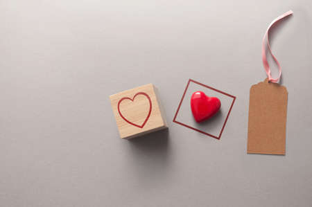 Two of a kind abstract concept, square around a heart and heart within a square wooden block and empty greeting cardの写真素材
