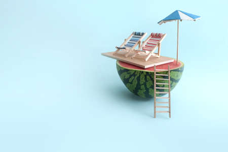 Summer watermelon with parasol,  two deck chairs and wooden beach ladderの写真素材