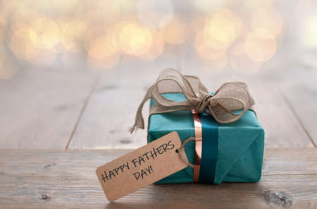 Wrapped gift with father day greeting label attachedの写真素材