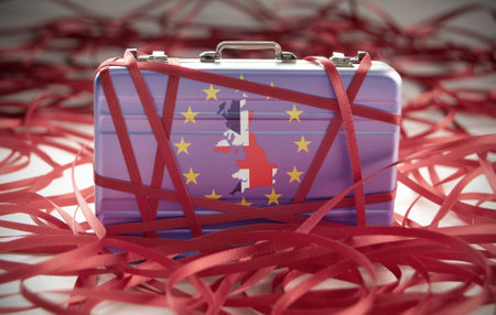 Red tape around a briefcase labeled taxの写真素材