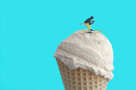 Miniature skier gliding on top of an ice cream cone, ski resort conceptの写真素材