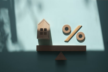 Wooden model House and percentage sign on a seesaw, property investment and house mortgage financial real estate balance conceptの写真素材