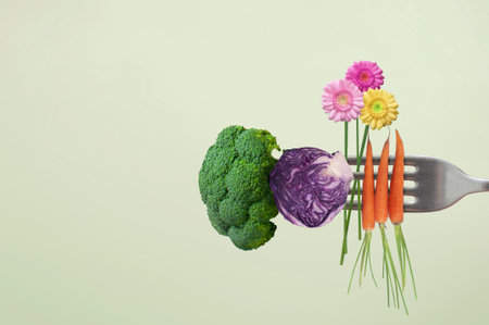 Closeup up of fork with freshly grown organic food with key ingredients including broccoli, cabbage; carrots and daisiesの写真素材