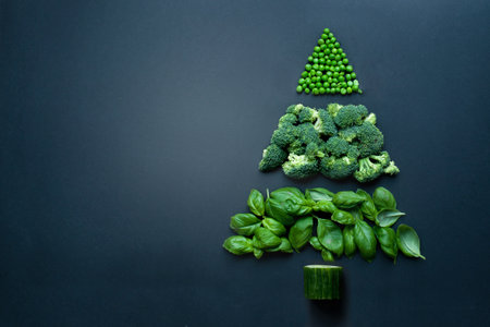 Healthy christmas tree made from healthy greens including broccoli, peas and basil leavesの写真素材