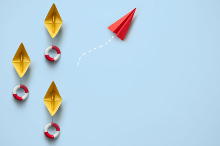 Red paper airplane amongst group of static boats, emerging as unique, success conceptの写真素材