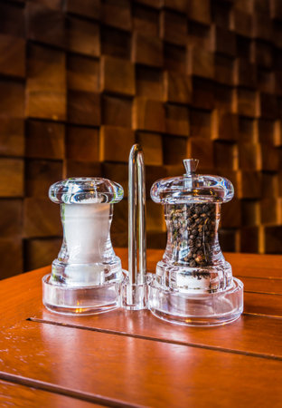 Salt and pepper shakers on a wooden backgroundの写真素材