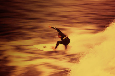 Surfing action blur with creative filters for the effect of surfing in fire waterの写真素材