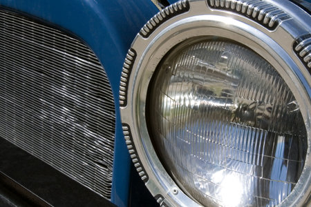 A close-up, abstract look at an old car's headlampの写真素材