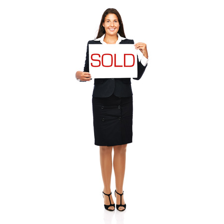 Businesswoman holding sold sign. Isolated on a withe background.
の写真素材