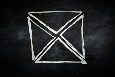 Envelope hand drawn on a blackboard with white chalkの写真素材