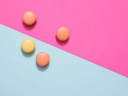 Sweet delicious macarons on vibrant colorful backgroundの写真素材