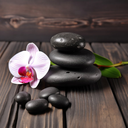zen basalt stones and orchid flower on the wooden background.の写真素材