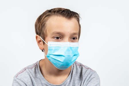 child with Covid 19 protective maskの写真素材