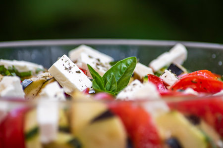 Greek salad with feta cheese, tomato, black olives and basilの写真素材