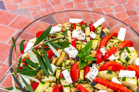 Greek salad with feta cheese, pepper, zucchini and tomatoの写真素材