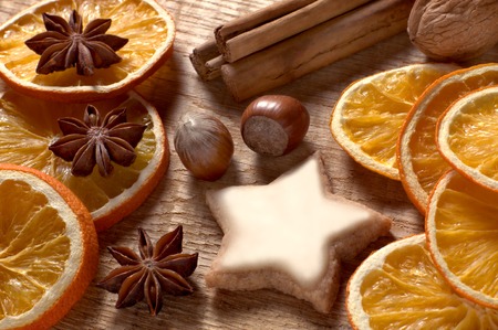 Christmas spices, nuts and cookies on wooden tableの写真素材