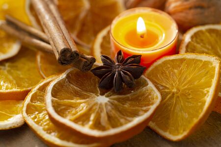 Orange slices, spices and scented candle as Christmas decorationの写真素材