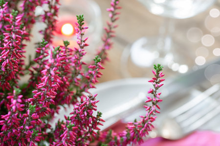 Festive decorated table with flowers, cutlery and wine glassの写真素材