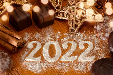 Festive turn of the year 2022 - year date with Christmas pastries and golden starsの写真素材